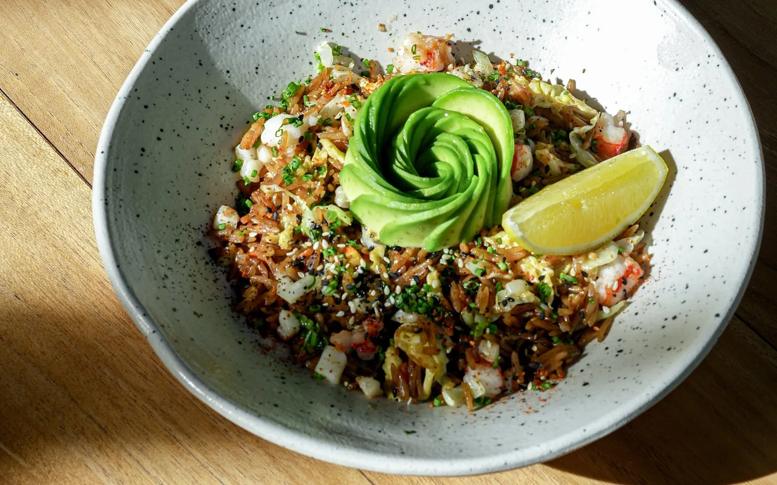 Avocado rice bowl with sliced avocado and lemon at The Avocado Factory