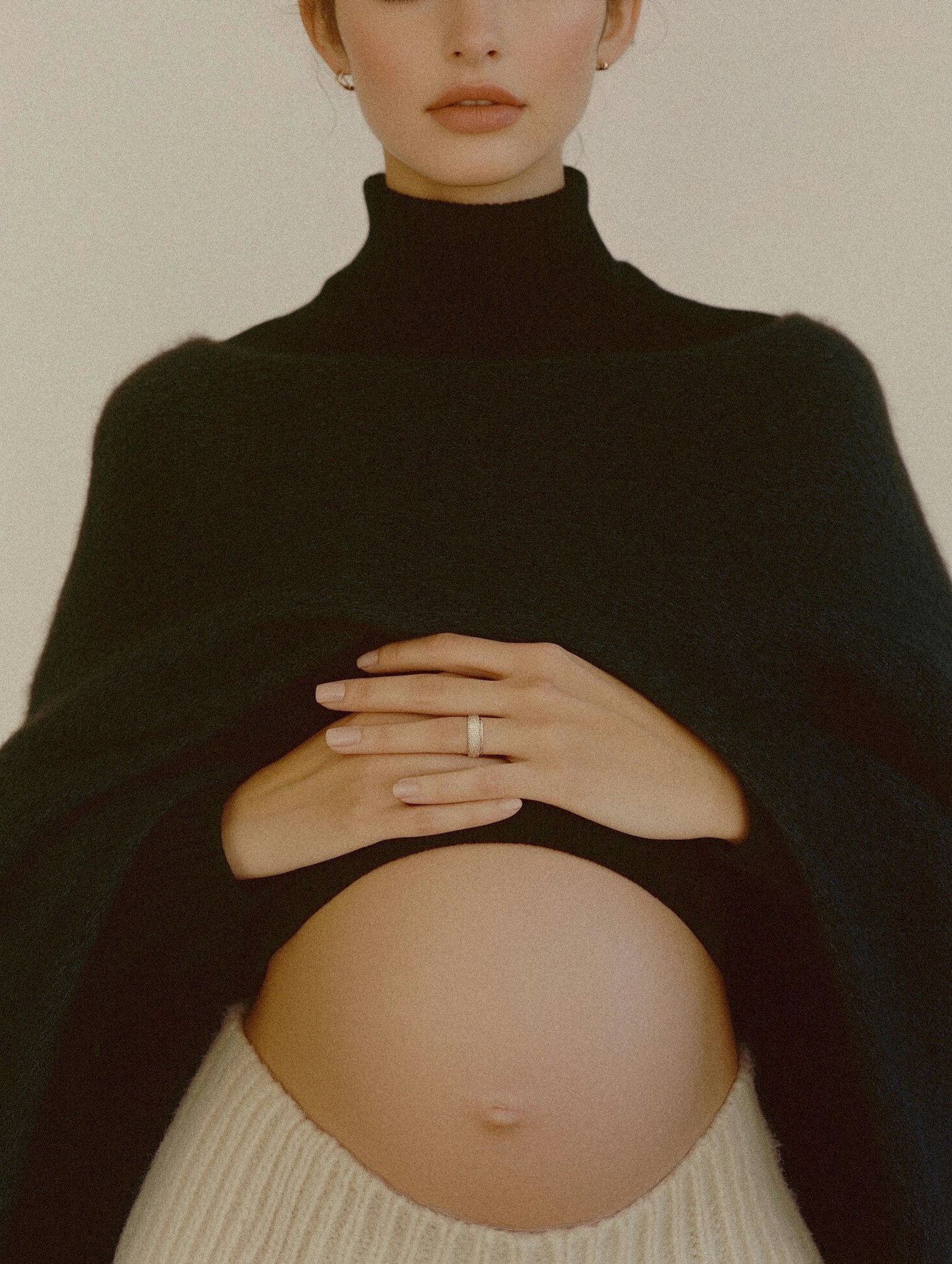 Pregnant woman resting hands on belly