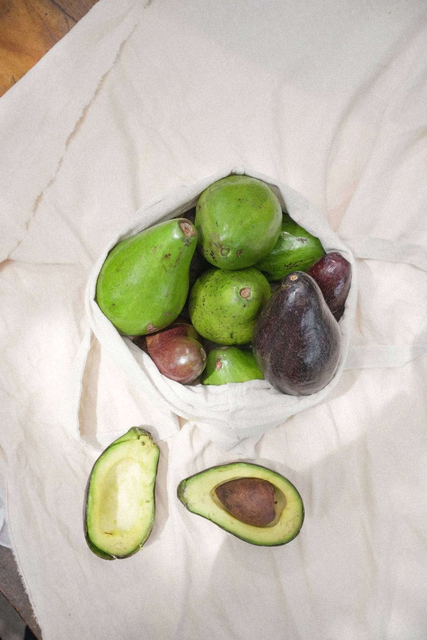 Freshly sourced avocados in a cotton tote